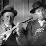 John Calvin Graham (left) and an unidentified man enjoy making music in the Dove community. Courtesy of Shivers family