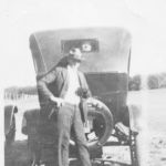 Claude Shivers behind his car. Unidentified man inside. Courtesy of Shivers family