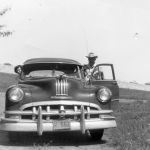 Wanda and Bill Stowe down in the Denton Creek bottomlands in 1954. Notice the automobiles on the roadway behind them over the dam. Courtesy of Wanda Stowe