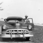 Wanda and Bill Stowe down in the Denton Creek bottomlands in 1954. Notice the automobiles on the roadway behind them over the dam. Courtesy of Wanda Stowe